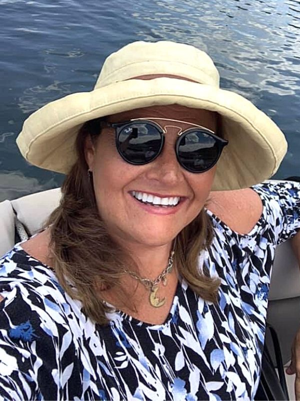 on a boat wearing a moon necklace